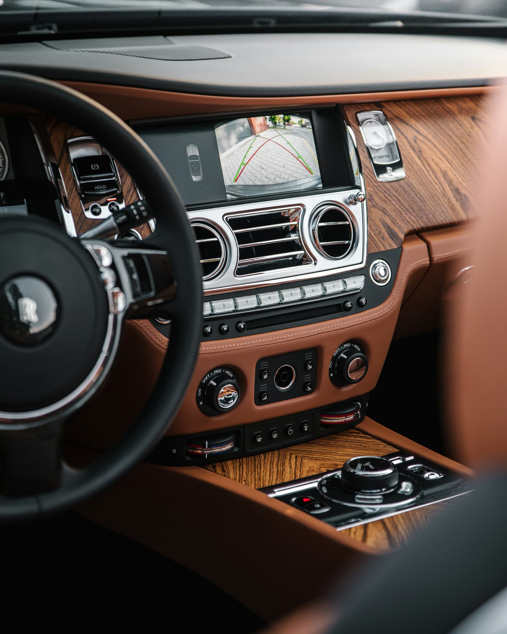 A vehicle dashboard, steering wheel and console in detail